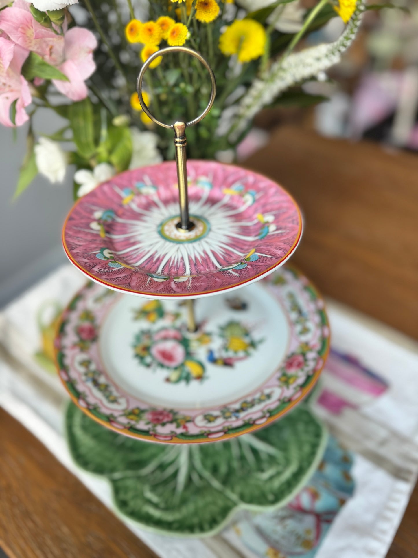 Three-tier china stand with pink Famille Rose plate, bok choy floral plate, and green Bordallo cabbage plate – elegant hostess serving tray
