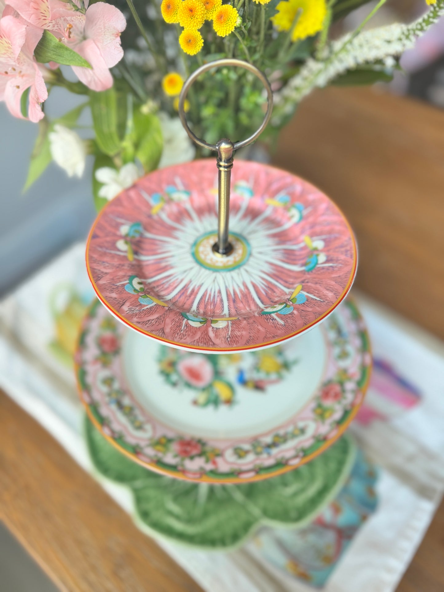 Three-tier china stand with pink Famille Rose plate, bok choy floral plate, and green Bordallo cabbage plate – elegant hostess serving tray