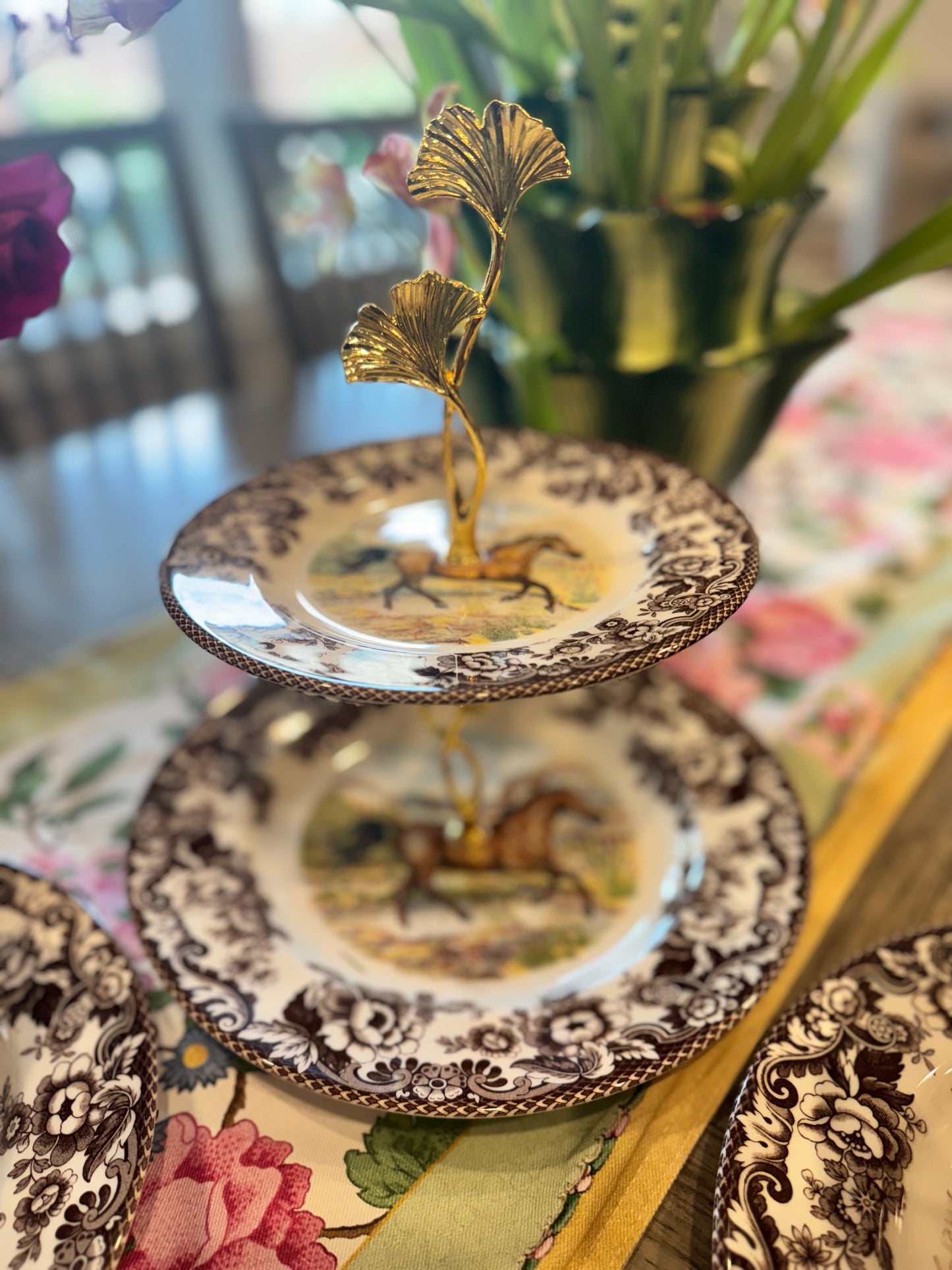 Two-tier stand made from Spode Woodland Horse plates with a ginkgo leaf handle and classic floral border.