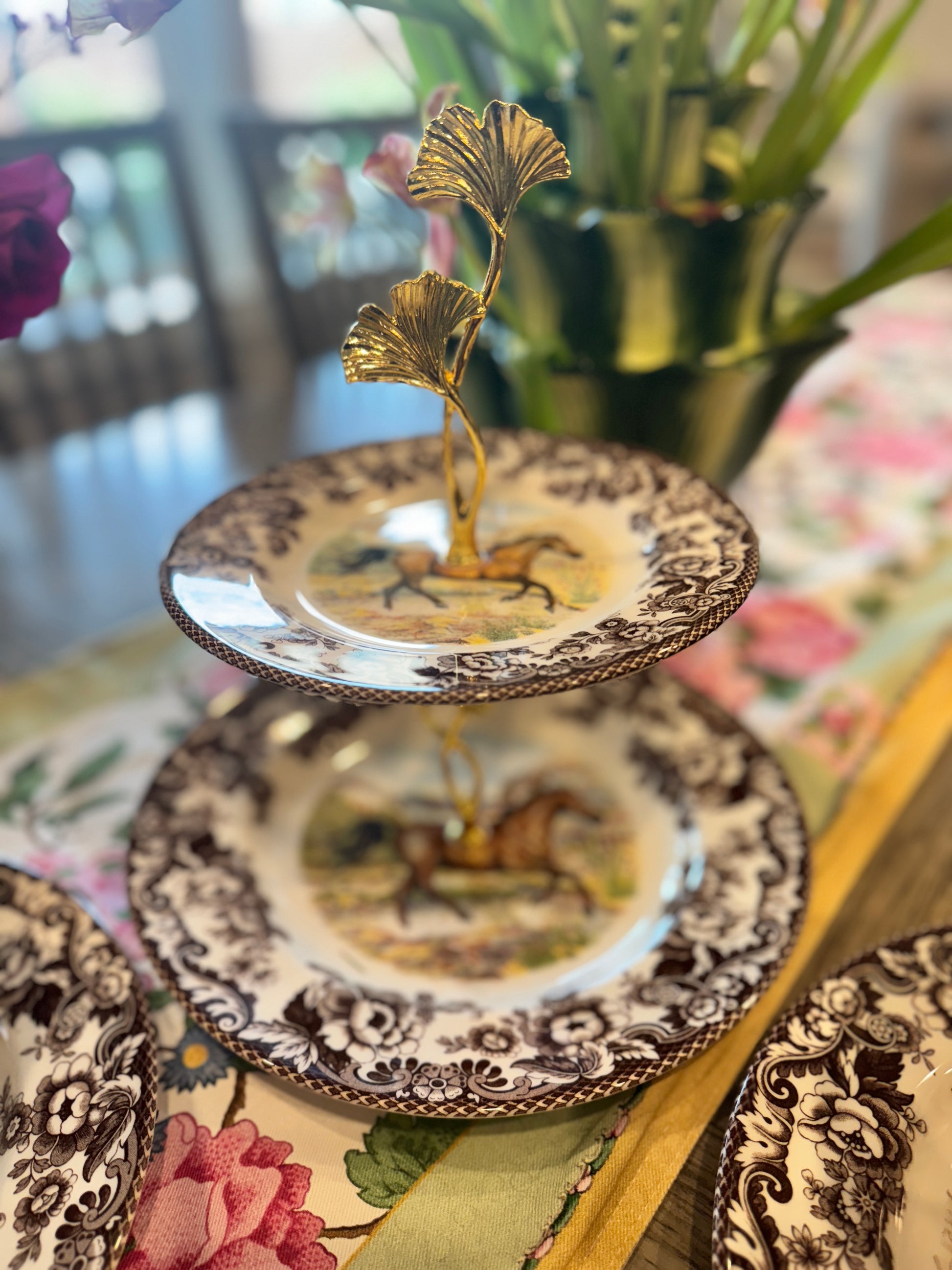 Two-tier stand made from Spode Woodland Horse plates with a ginkgo leaf handle and classic floral border.