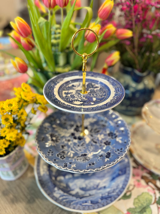 Three-tiered stand made from mixed blue and white English transferware plates with gold hardware