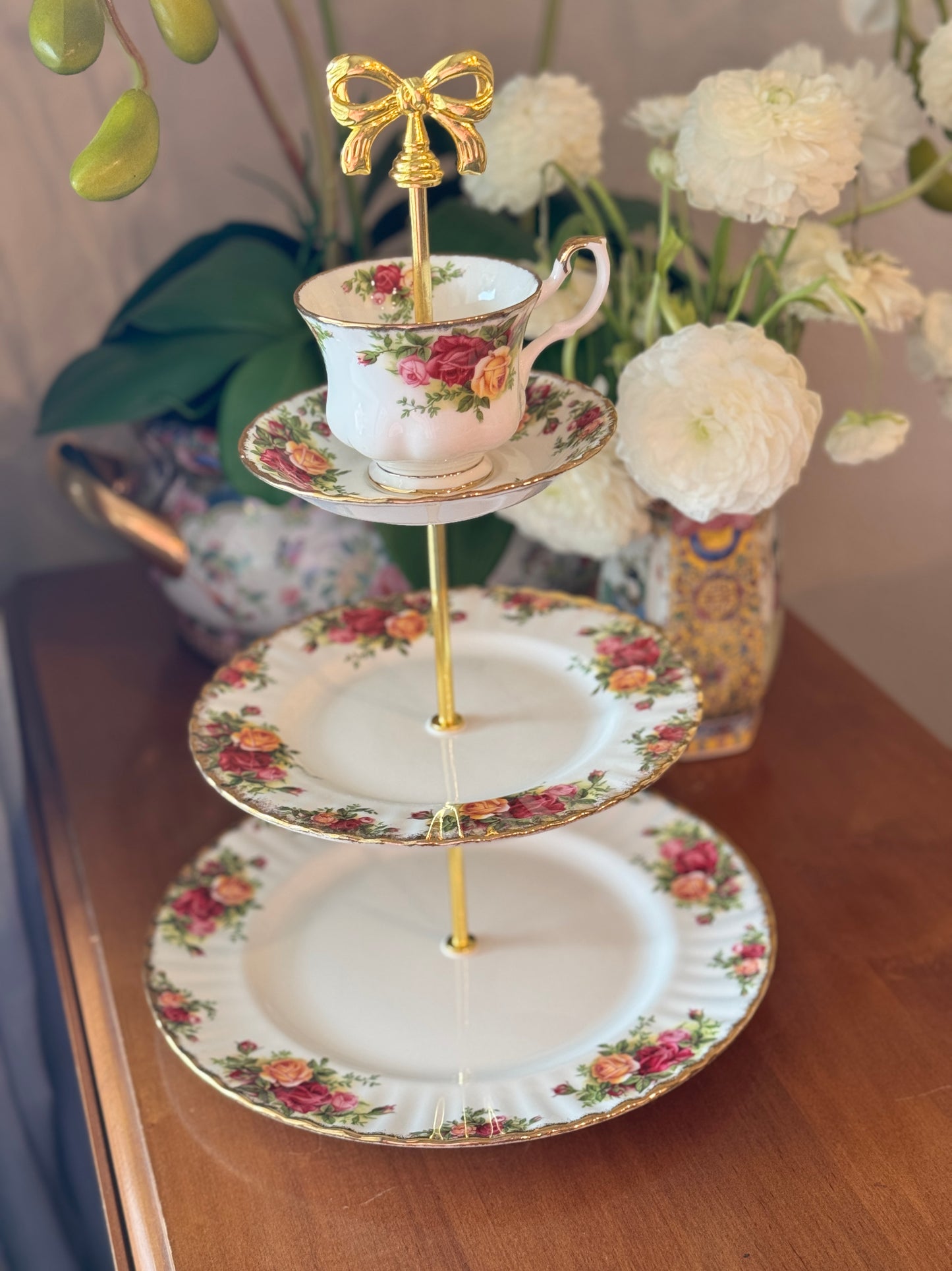 Three-tier stand made with Royal Albert Old Country Roses china and topped with a matching teacup.