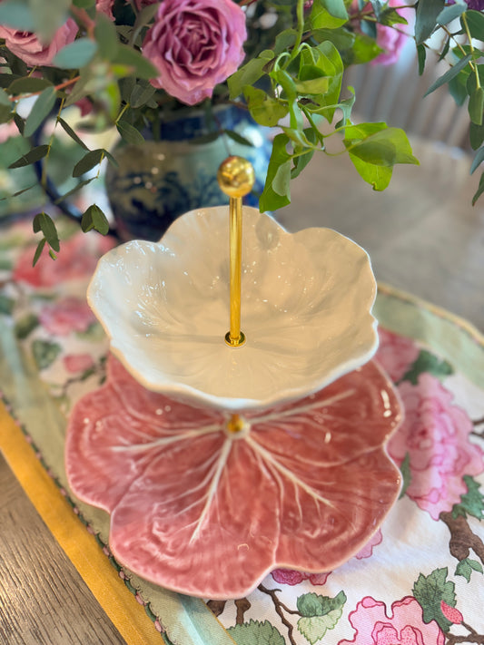 Pink and cream two-tiered Bordallo cabbage plate stand with customizable gold hardware, styled with lush florals and vibrant linens.