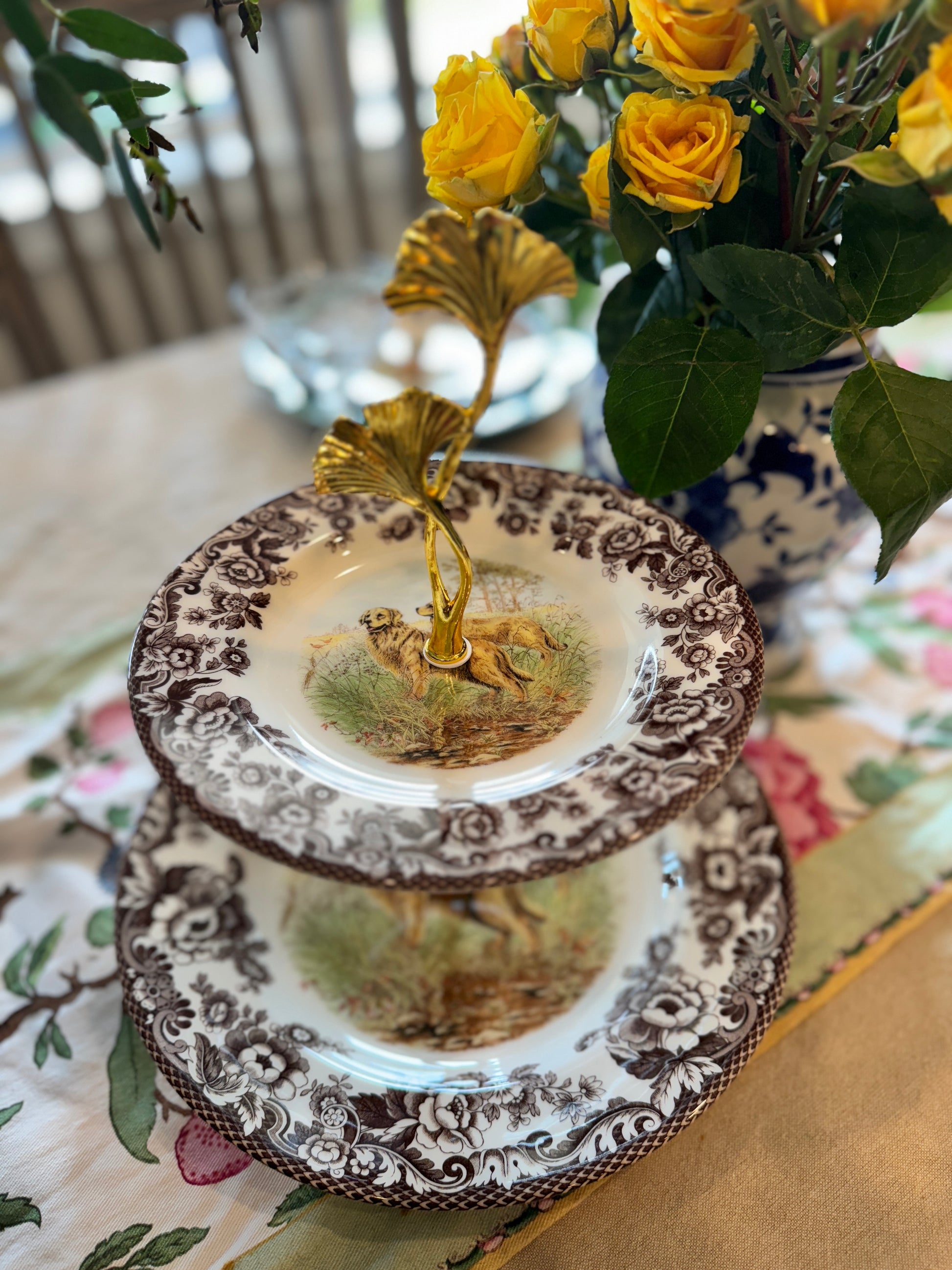 Two-tier stand made from Spode Woodland plates with a Golden Retriever hunting scene and floral borders.