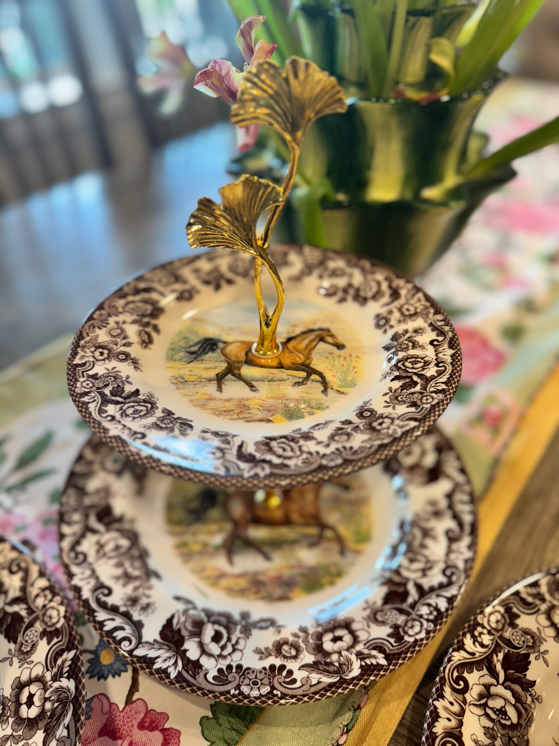 Two-tier stand made from Spode Woodland Horse plates with a ginkgo leaf handle and classic floral border.