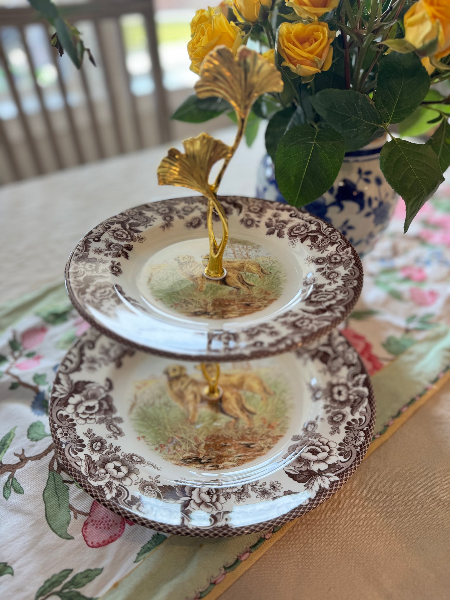 Two-tier stand made from Spode Woodland plates with a Golden Retriever hunting scene and floral borders.