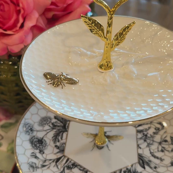 Three-tier stand made from Williams Sonoma Beehive collection plates with honeycomb, botanical, and bee designs, accented with gold hardware – perfect for hosting and entertaining.